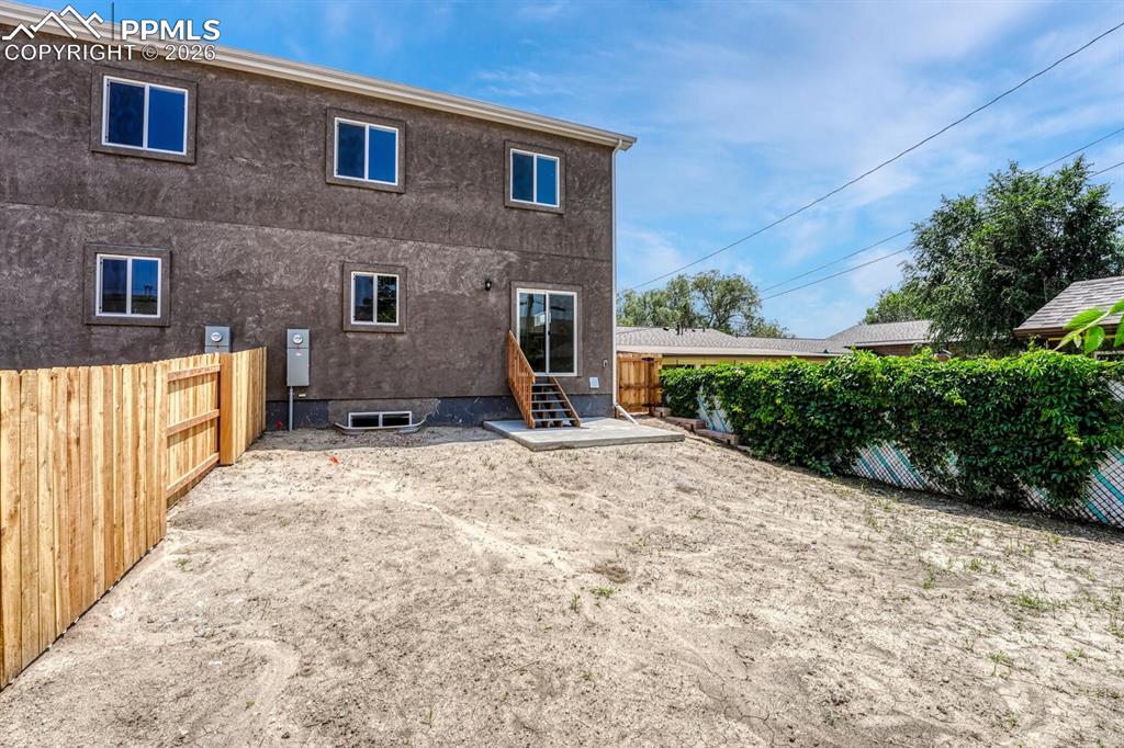 Image 25 of 34: Sizable backyard is fully fenced for privacy and pets.