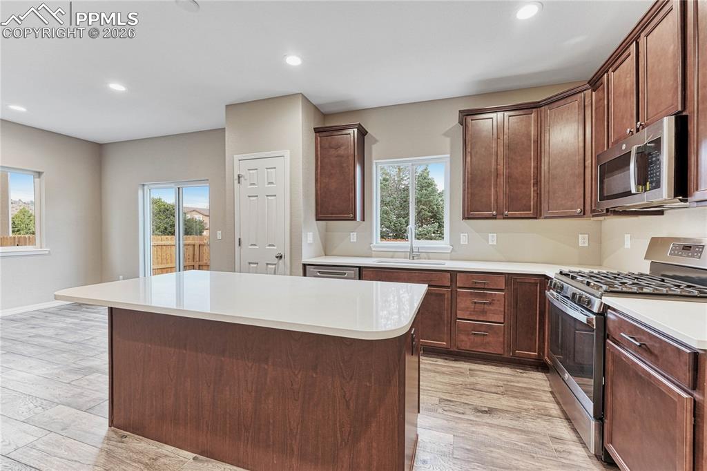 Image 7 of 34: 42" extended height cabinetry, stone countertops, optional pendant lighting