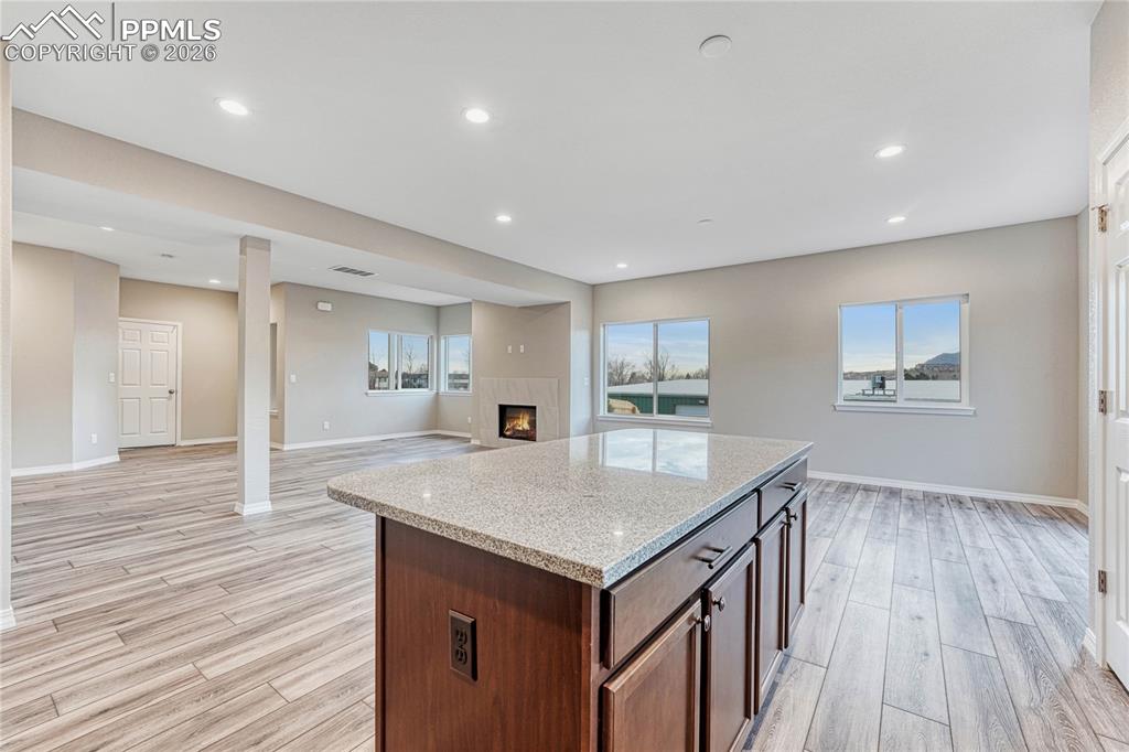 Image 8 of 34: Bar-top kitchen island is perfect for quick meals, coffee sipping, and gath