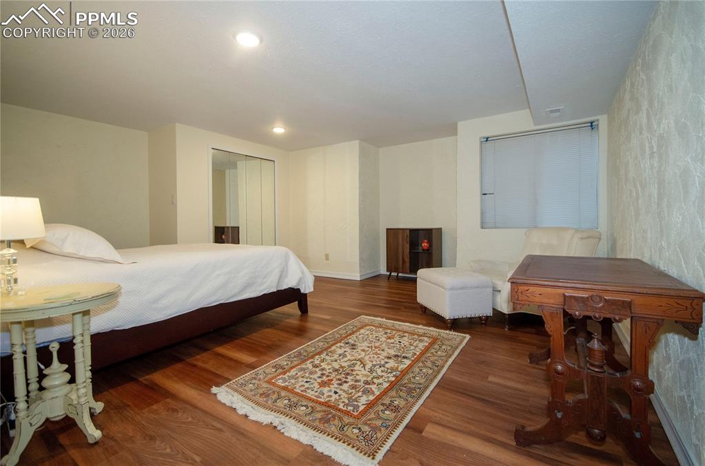 Image 34 of 49: Basement family room, pictured here being used as a bedroom