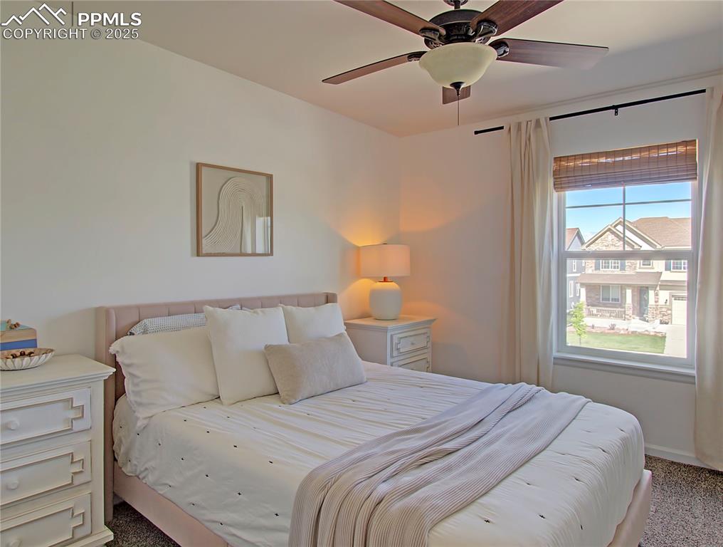 Image 24 of 44: Carpeted bedroom featuring ceiling fan and baseboards