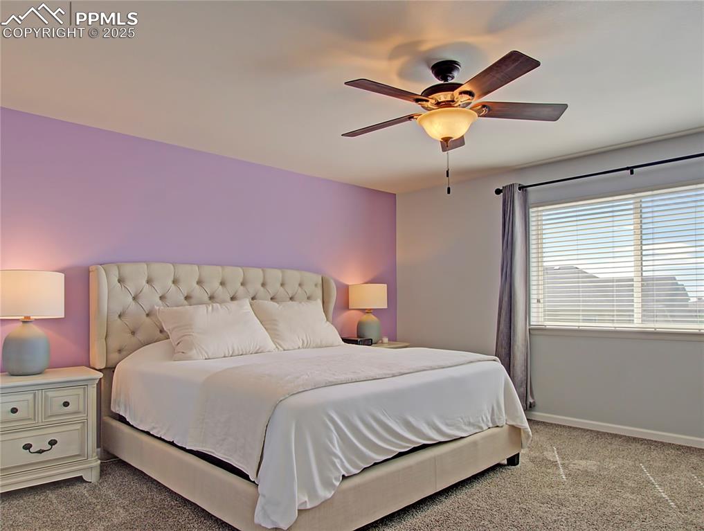 Image 25 of 44: Bedroom with light carpet and ceiling fan