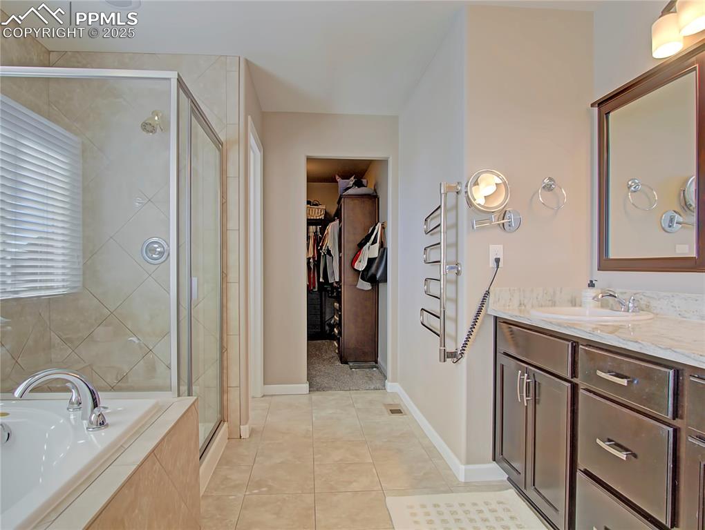 Image 27 of 44: Full bathroom featuring a spacious closet, light tile patterned floors, van