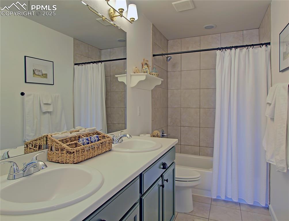 Image 29 of 44: Full bath featuring light tile patterned floors, shower / bath combo with s