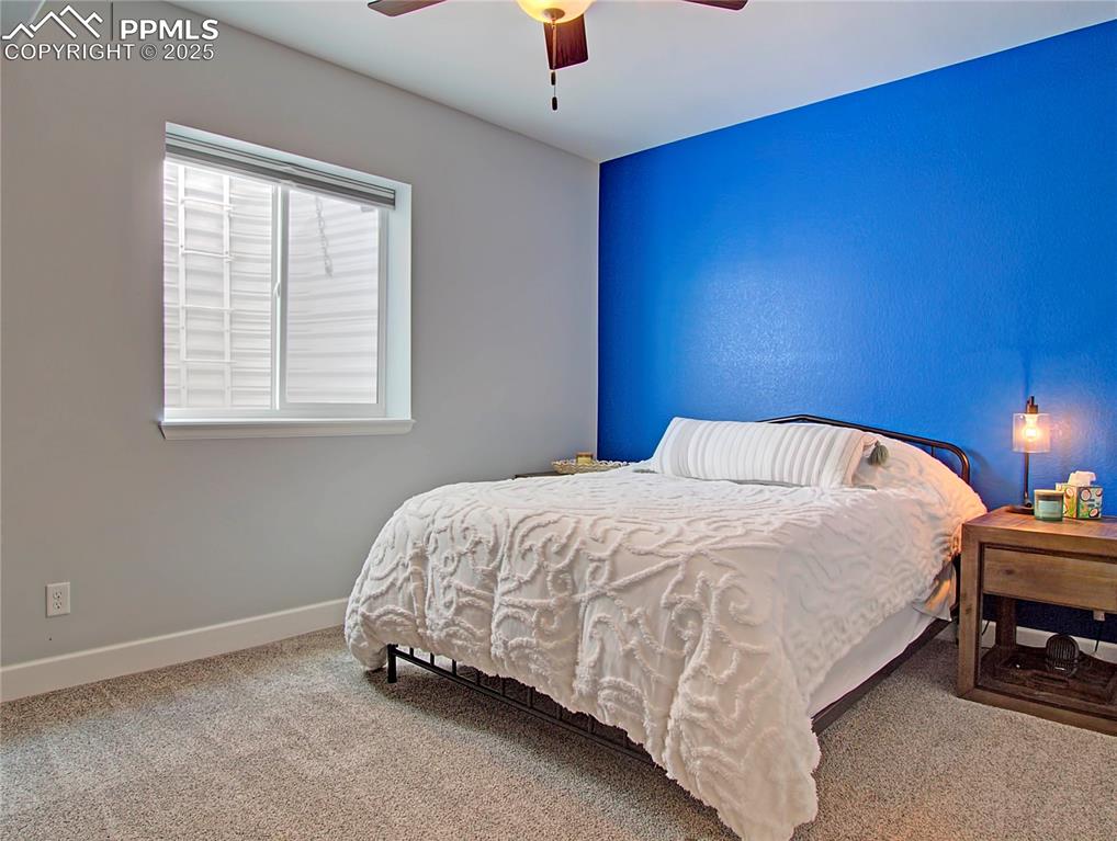 Image 34 of 44: Bedroom with carpet and ceiling fan