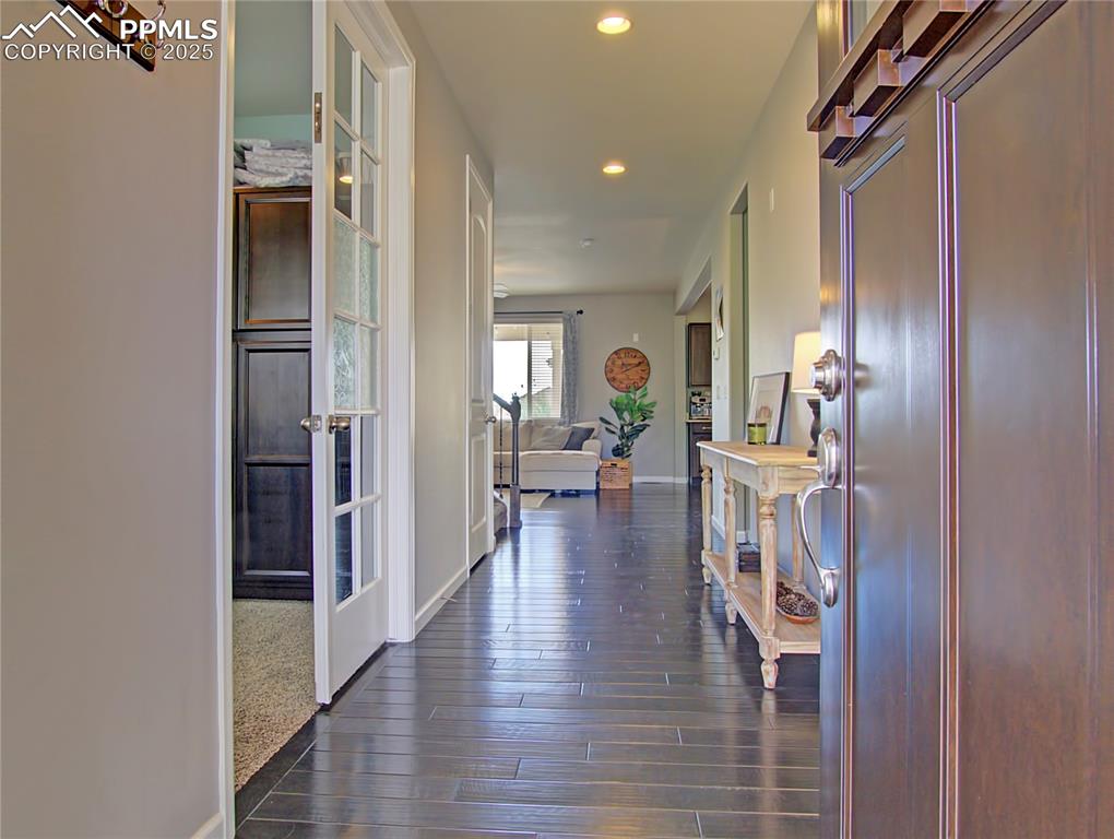 Image 4 of 44: Office space featuring French doors, light carpet and baseboards