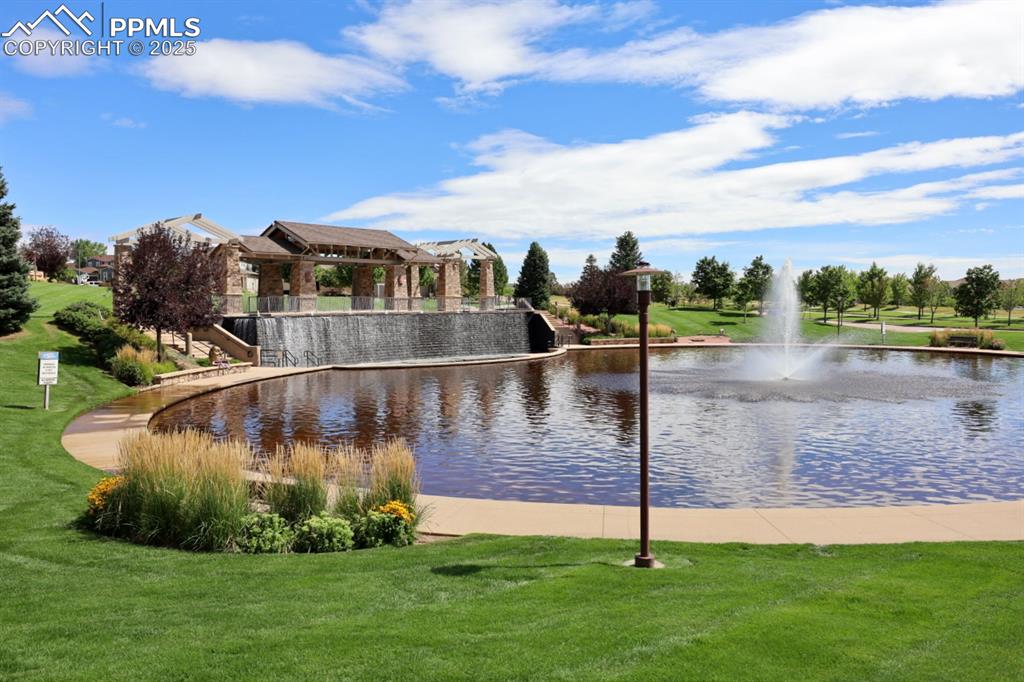 Image 41 of 44: Surrounding community with a water view and a lawn