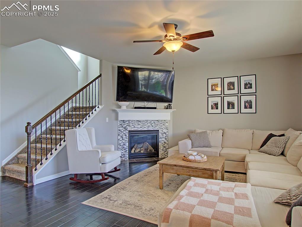 Image 6 of 44: Entryway with dark wood finished floors, stairs, and recessed lighting