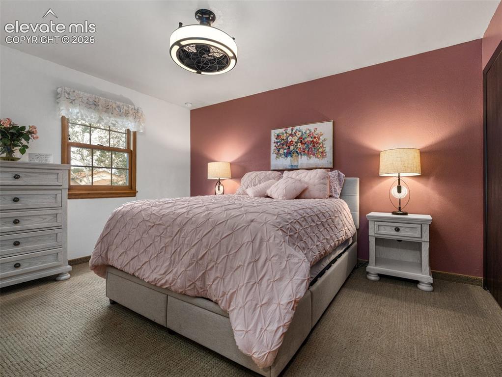 Image 15 of 34: Ceiling fan with integrated lighting, wood-frame window, textured carpet, a