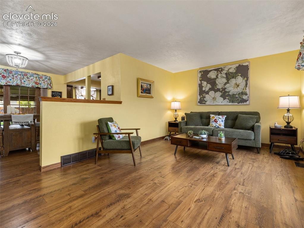 Image 2 of 34: Wood-finish flooring throughout the space