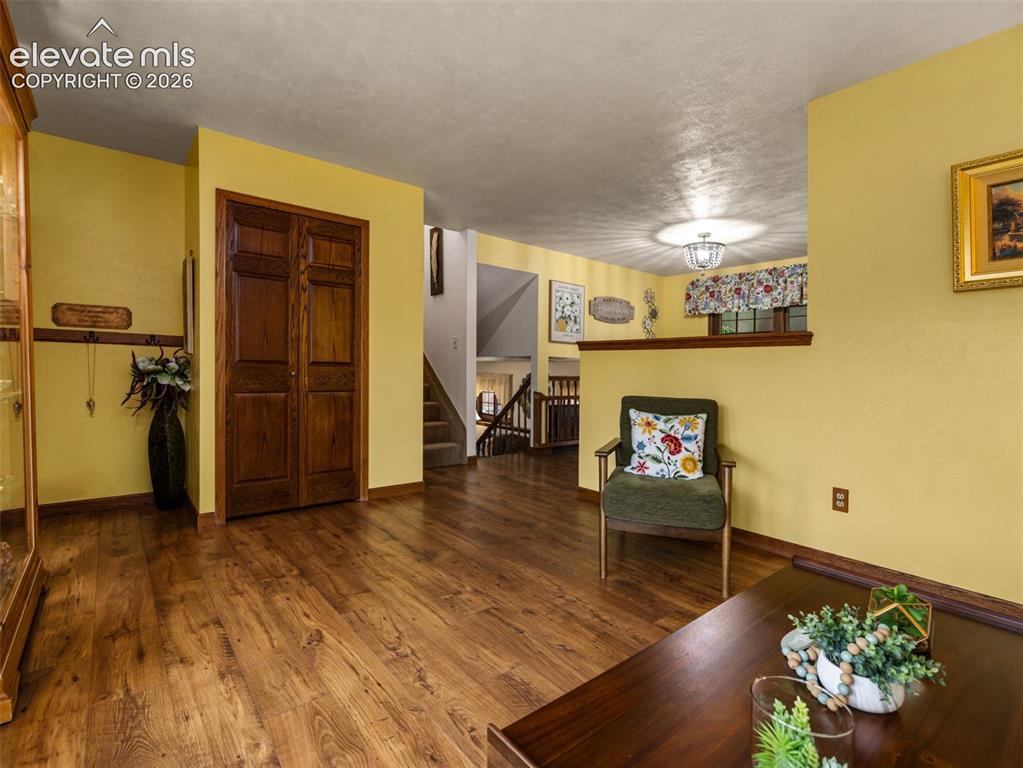 Image 4 of 34: Wood-finish flooring throughout, solid wood bi-fold doors, and a built-in w