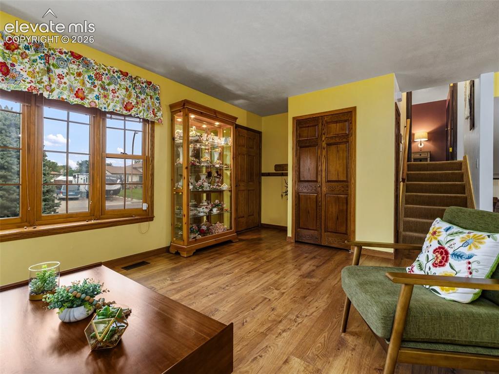 Image 5 of 34: Wood-finish flooring throughout, multi-pane windows with wood trim, and woo