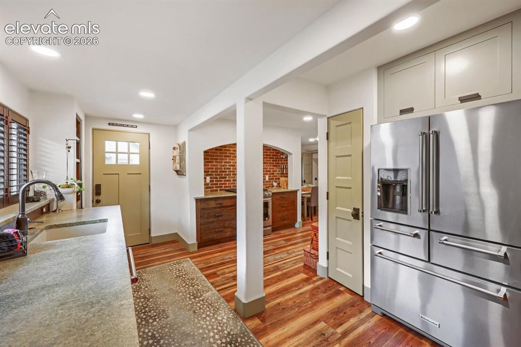 Image 15 of 30: Kitchen featuring wood-finish flooring, recessed lighting, and a stainless 