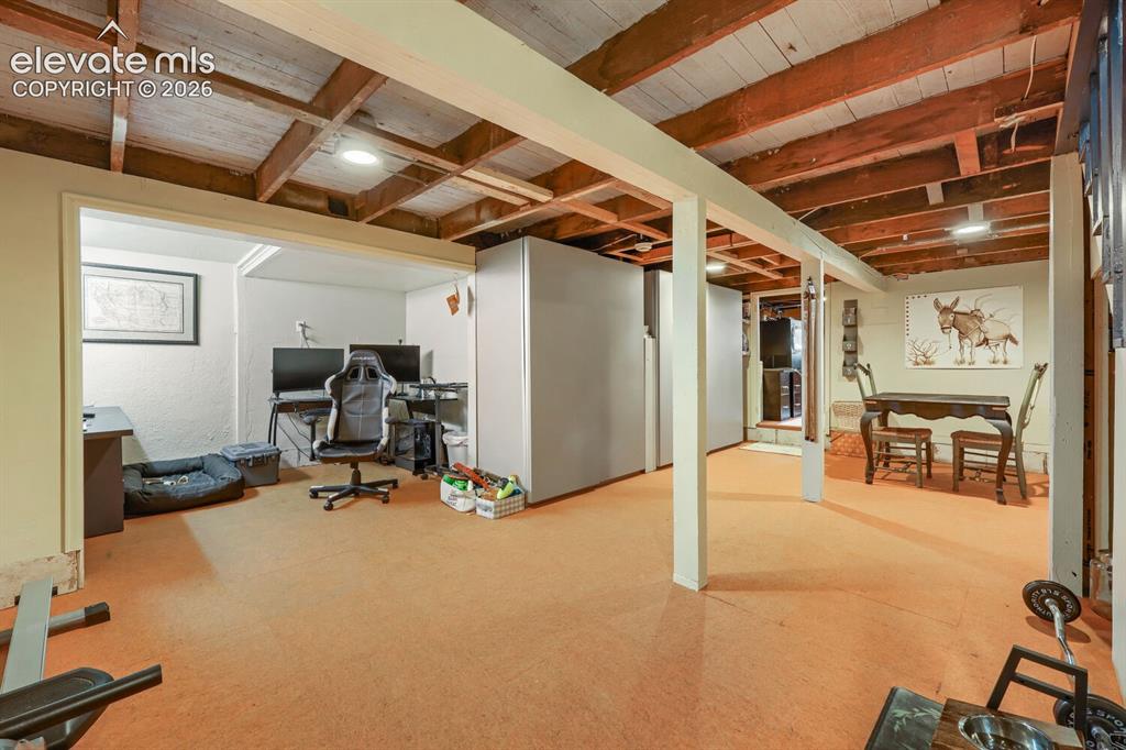 Image 25 of 30: Exposed wood beam ceiling with recessed lighting
