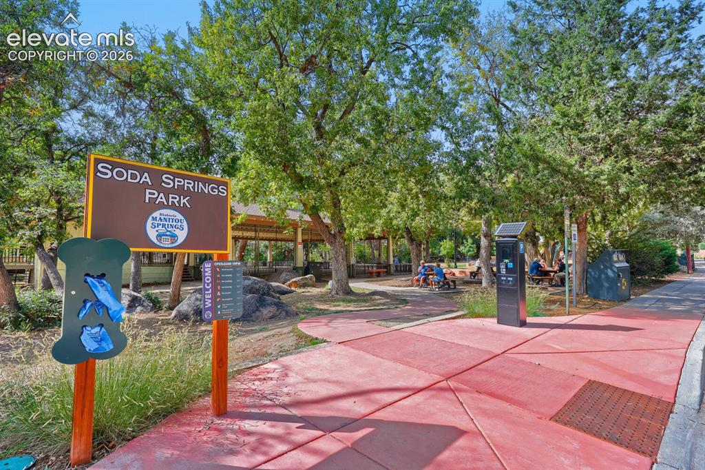 Image 26 of 30: Soda Springs Park entrance featuring a prominent park sign, a red-paved pat