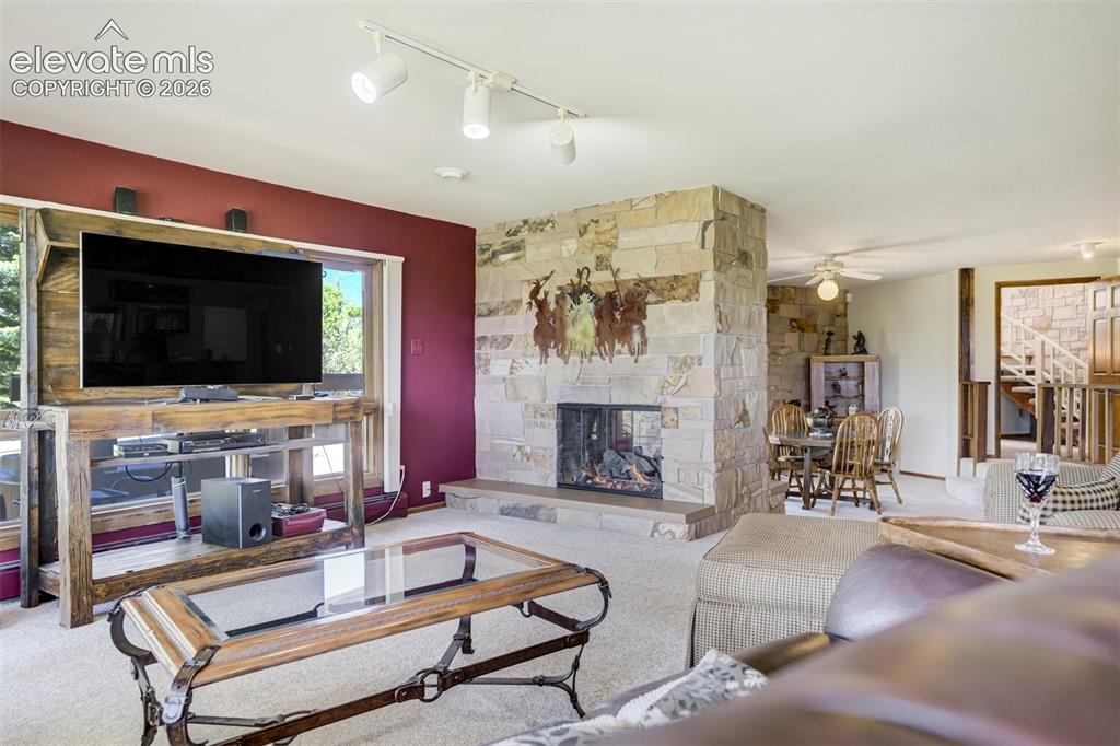 Image 34 of 50: Family room entertainment area with see through fireplace.