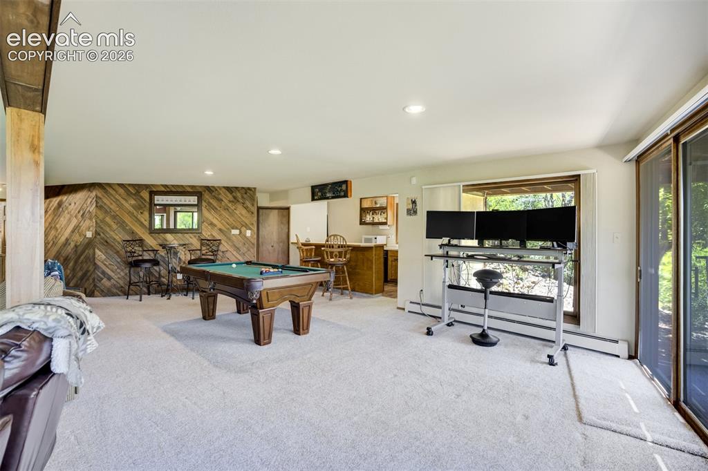 Image 35 of 50: Billards area of Family Room with wet bar.