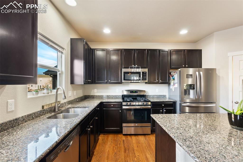 Image 11 of 33: Kitchen with granite countertops and stainless appliances.