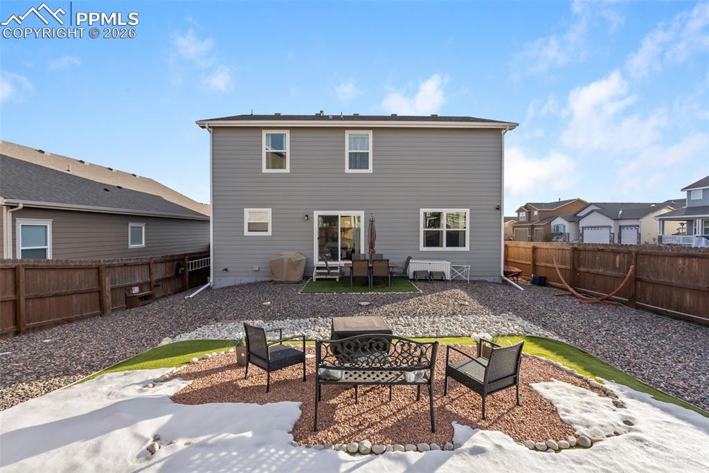 Image 26 of 33: Rear exterior with large fully fenced yard.