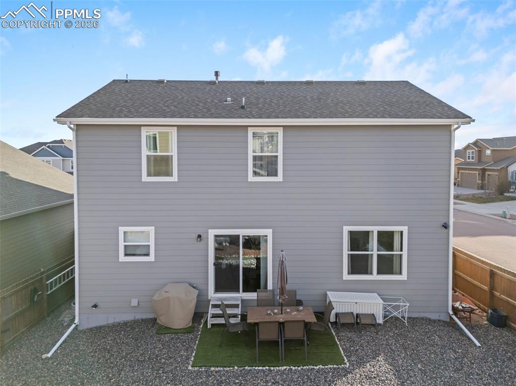 Image 27 of 33: Back of home with walkout access.