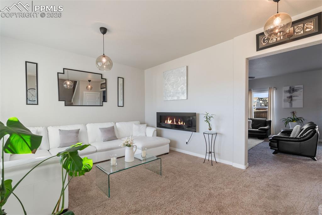 Image 3 of 33: Bright sitting room with modern light fixtures.