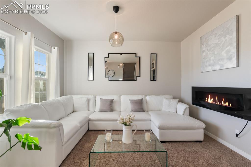Image 4 of 33: Inviting sitting room with natural light.