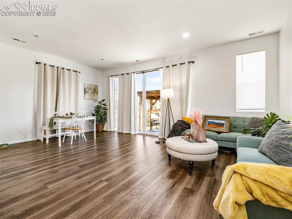 Image 14 of 26: Living area featuring wood finished floors and recessed lighting