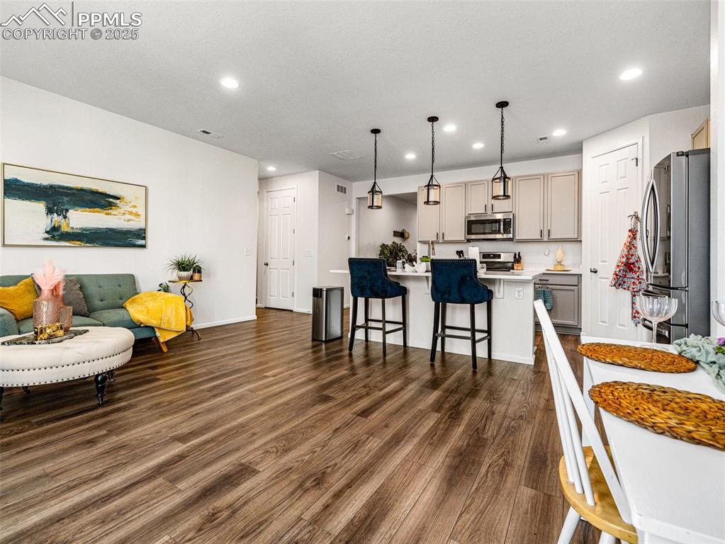Image 16 of 26: Kitchen featuring stainless steel appliances, a kitchen island with sink, d