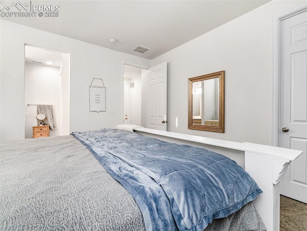 Image 20 of 26: Bedroom with carpet