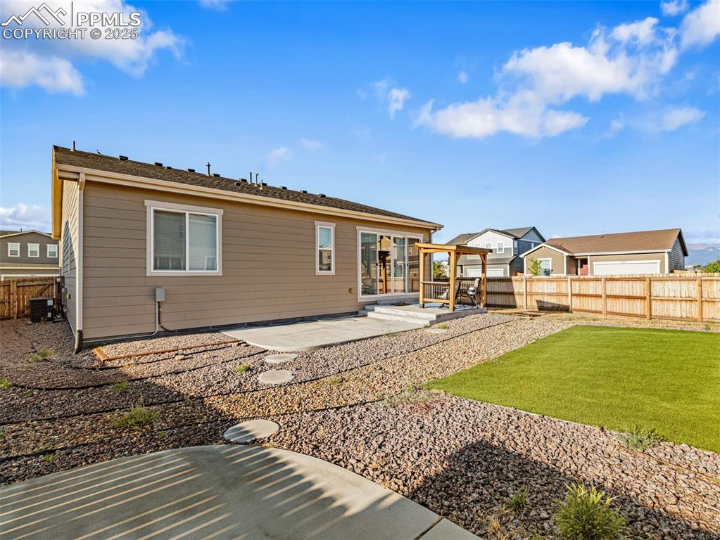 Image 25 of 26: Back of property with a fenced backyard and a patio area