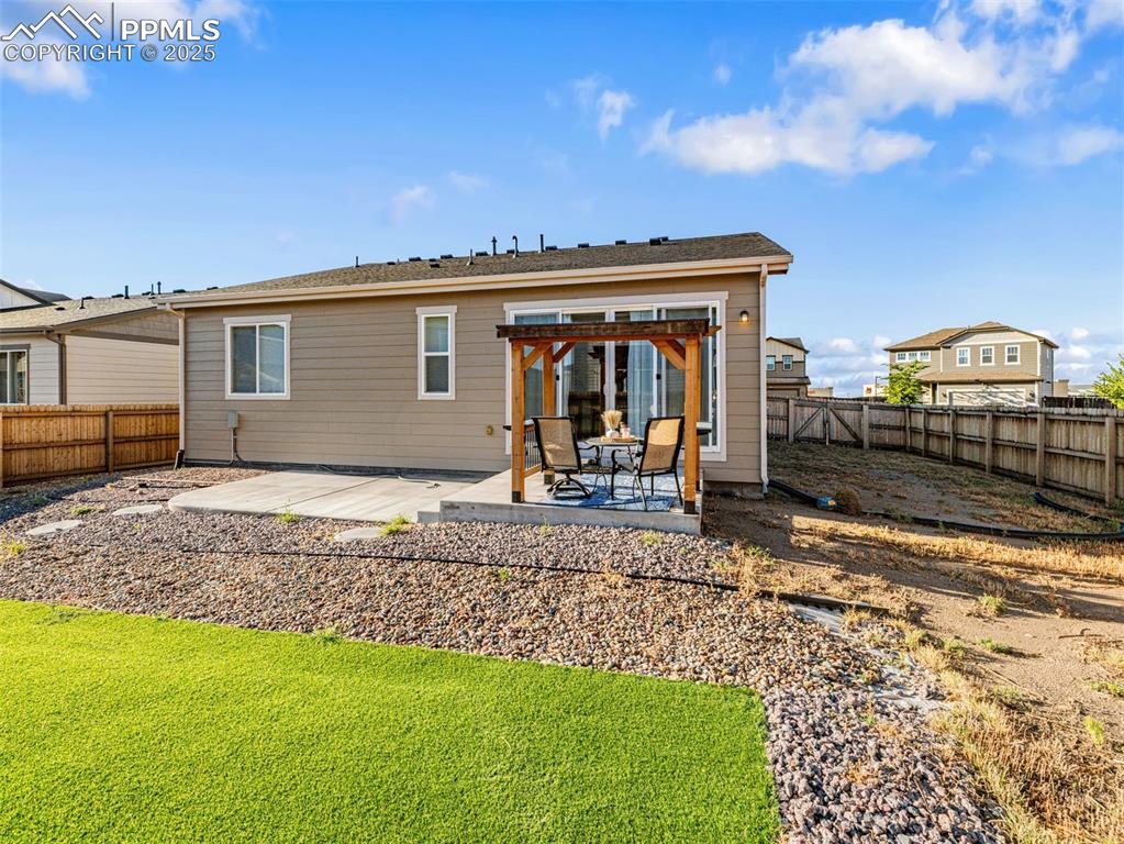 Image 26 of 26: Back of property with a patio and a fenced backyard