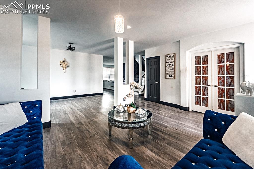 Image 2 of 47: Living room featuring dark wood finished floors and french doors
