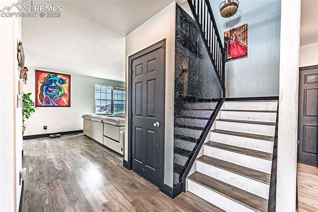 Image 27 of 47: Stairs with wood finished floors