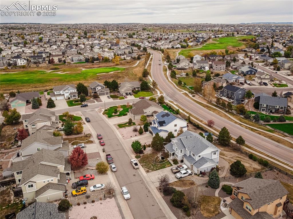 Image 37 of 47: Aerial view of residential area featuring a golf course