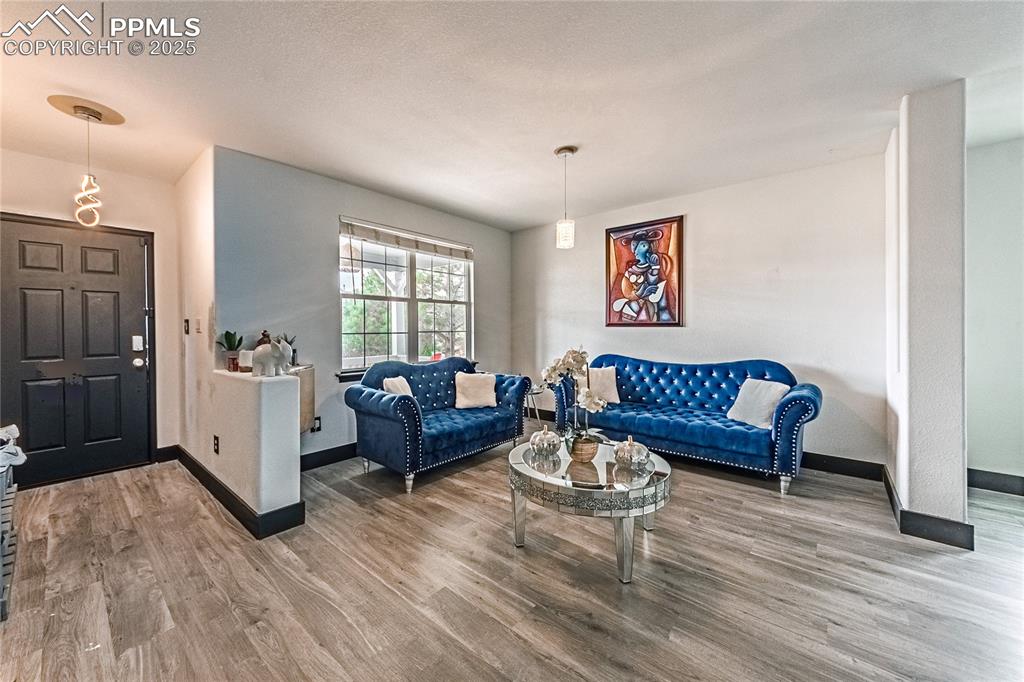 Image 6 of 47: Living room featuring light wood-style floors and baseboards