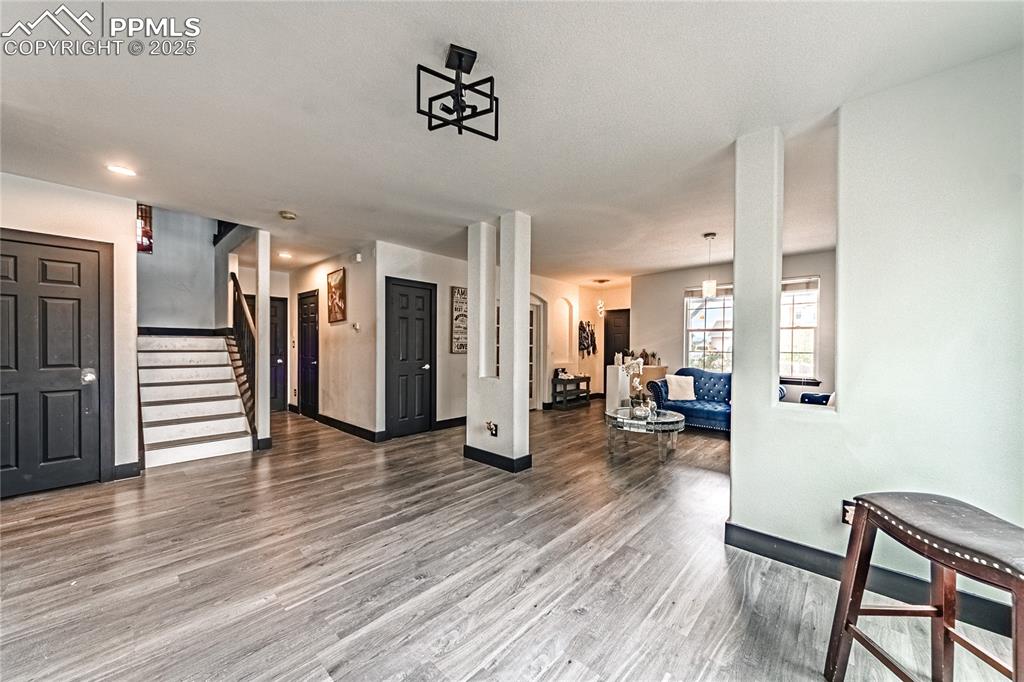 Image 9 of 47: Living room with stairs and light wood-type flooring