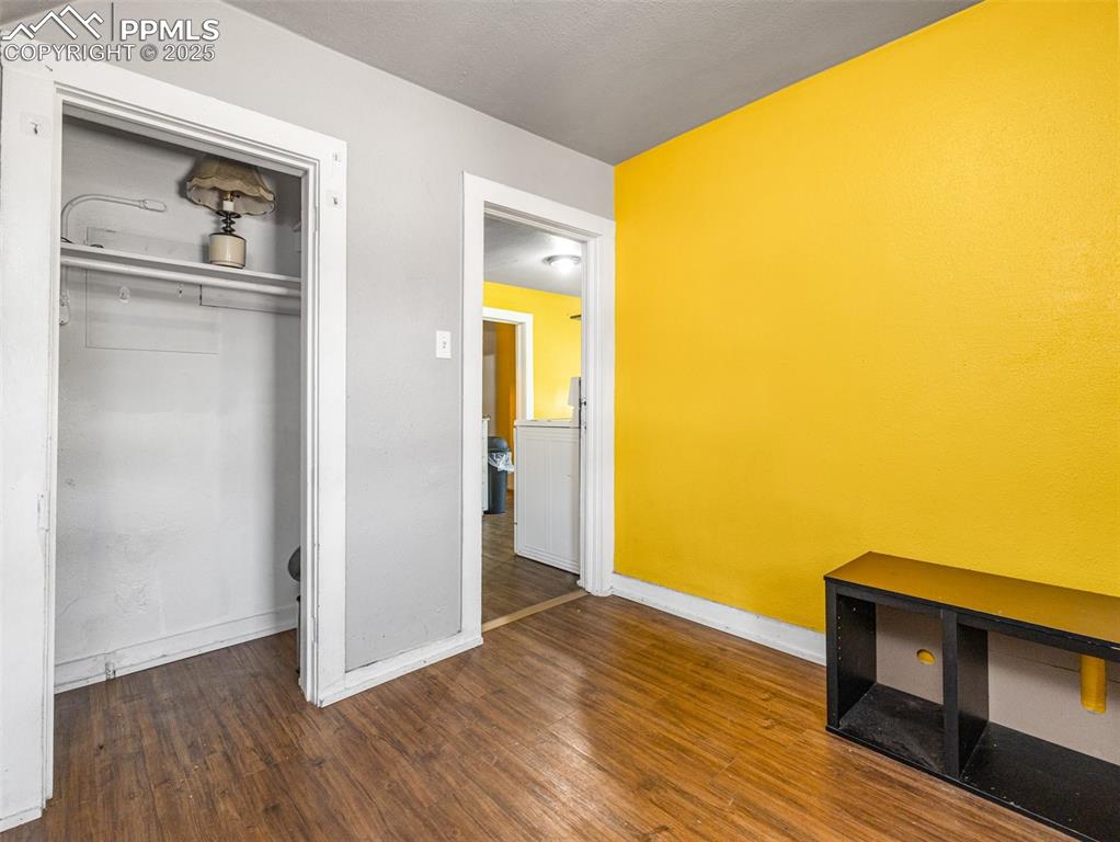 Image 17 of 30: Unfurnished bedroom with dark wood-type flooring and a closet