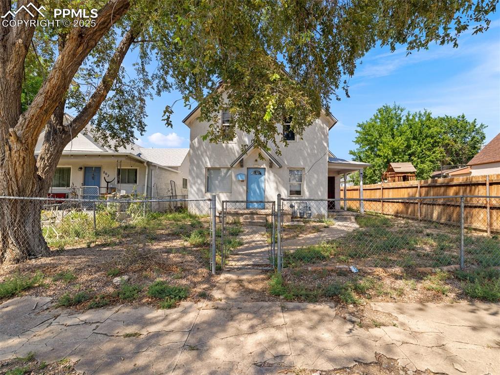 Image 18 of 30: Blue door is entrance to main level unit