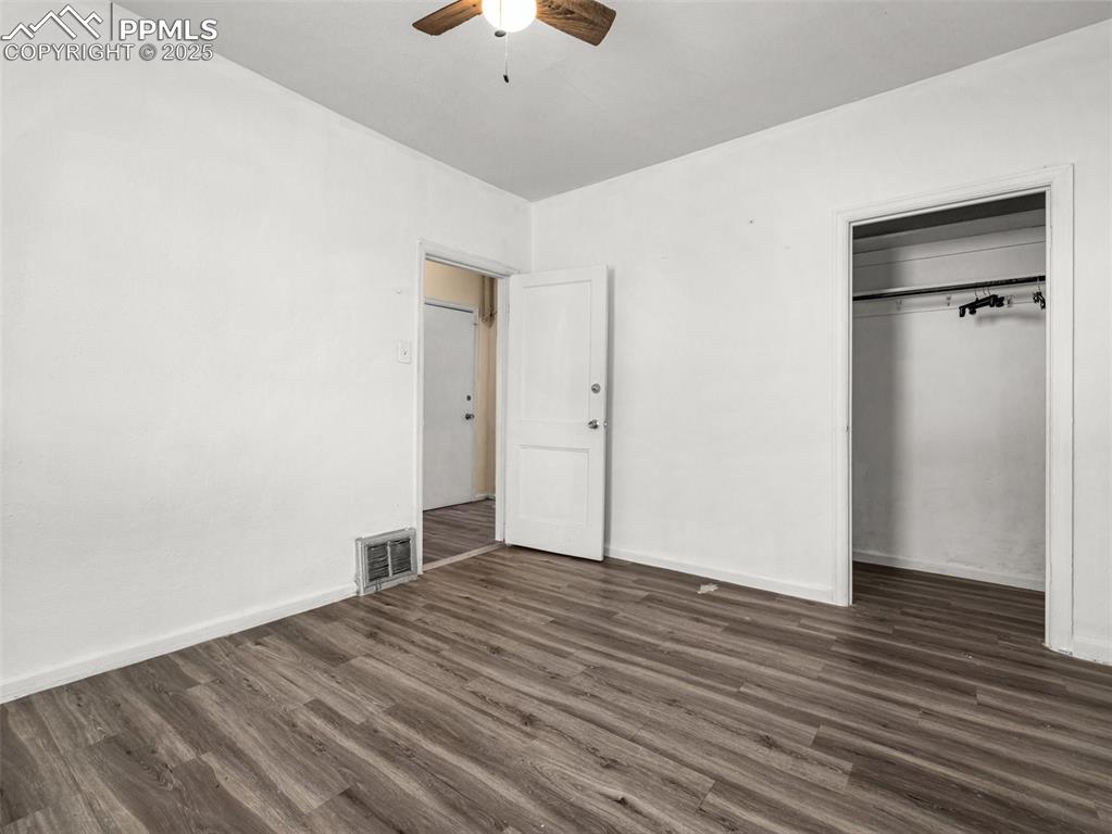 Image 30 of 30: Unfurnished bedroom with dark wood-type flooring, a closet, and a ceiling f