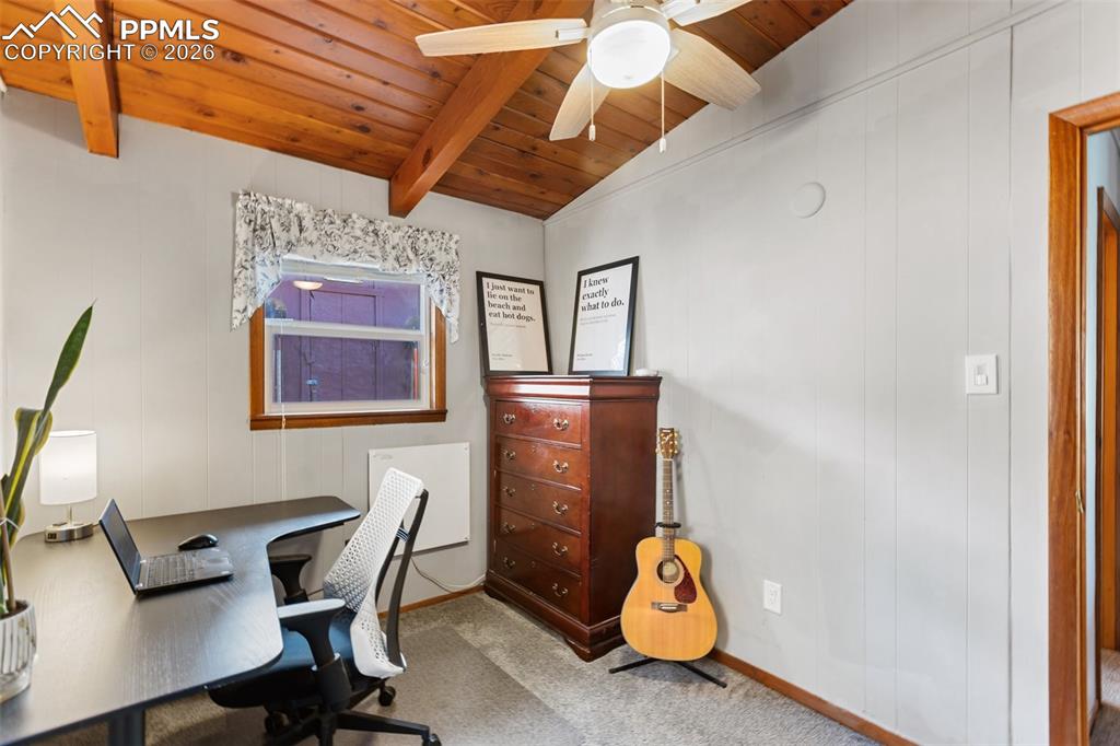 Image 16 of 46: 2nd bedroom featuring a wooden ceiling with exposed beams, ceiling fan