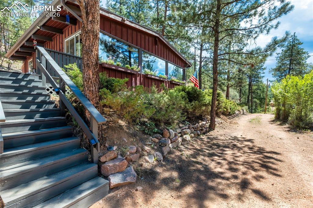 Image 2 of 46: View of yard featuring stairway and front of home