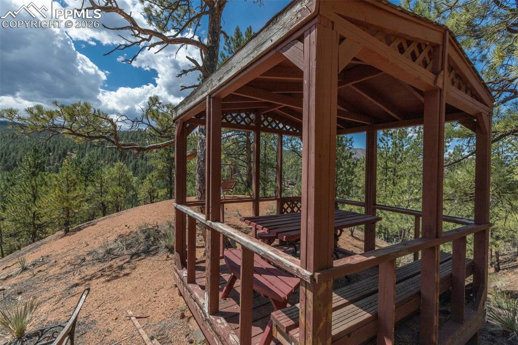 Image 24 of 46: Wooden gazebo with a view at top of the hill behind property