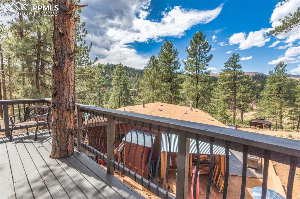 Image 32 of 46: Wooden deck featuring a forest view