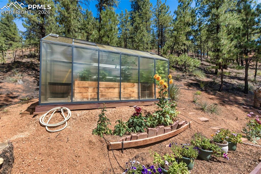 Image 46 of 46: Green house with solar and garden area