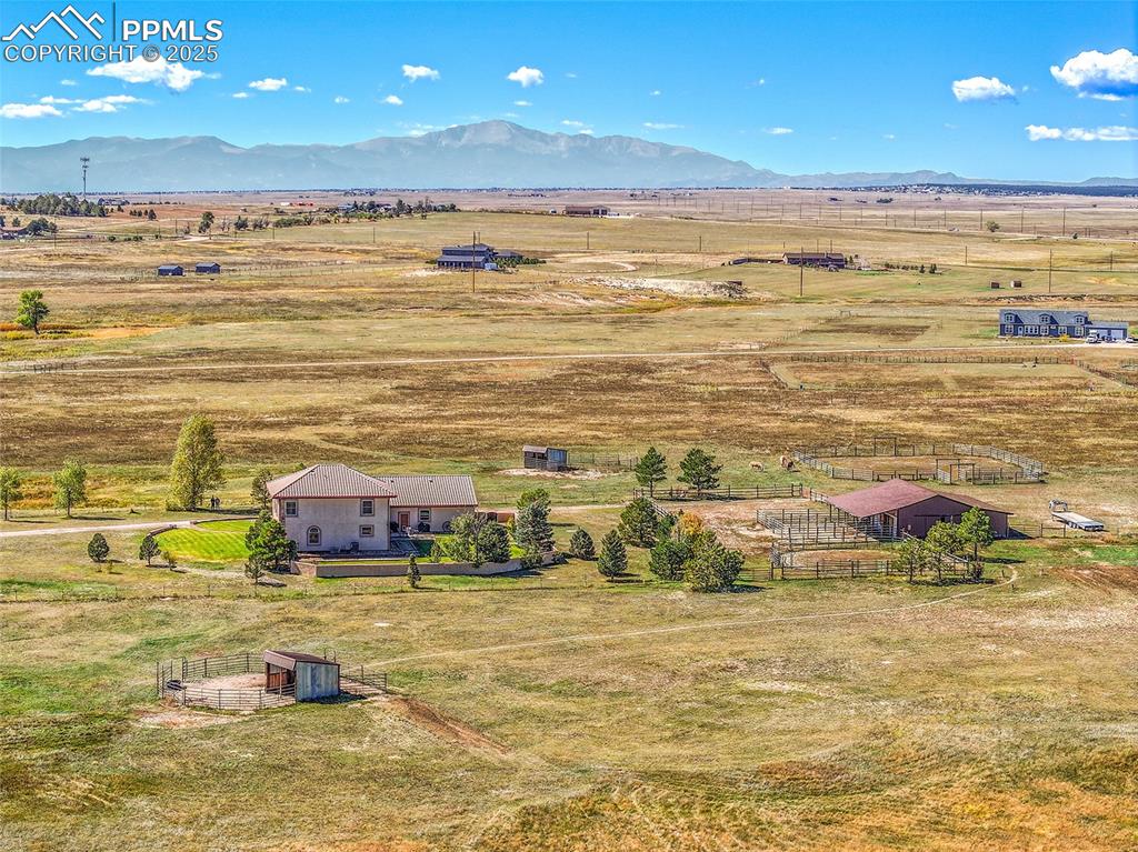 Image 3 of 49: 2 loafing sheds, 4 stall horse barn, and corral