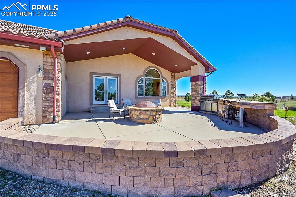 Image 46 of 49: Covered Patio and built in BBQ