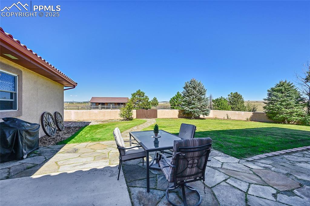 Image 5 of 49: Back Patio- Gate leads to barn