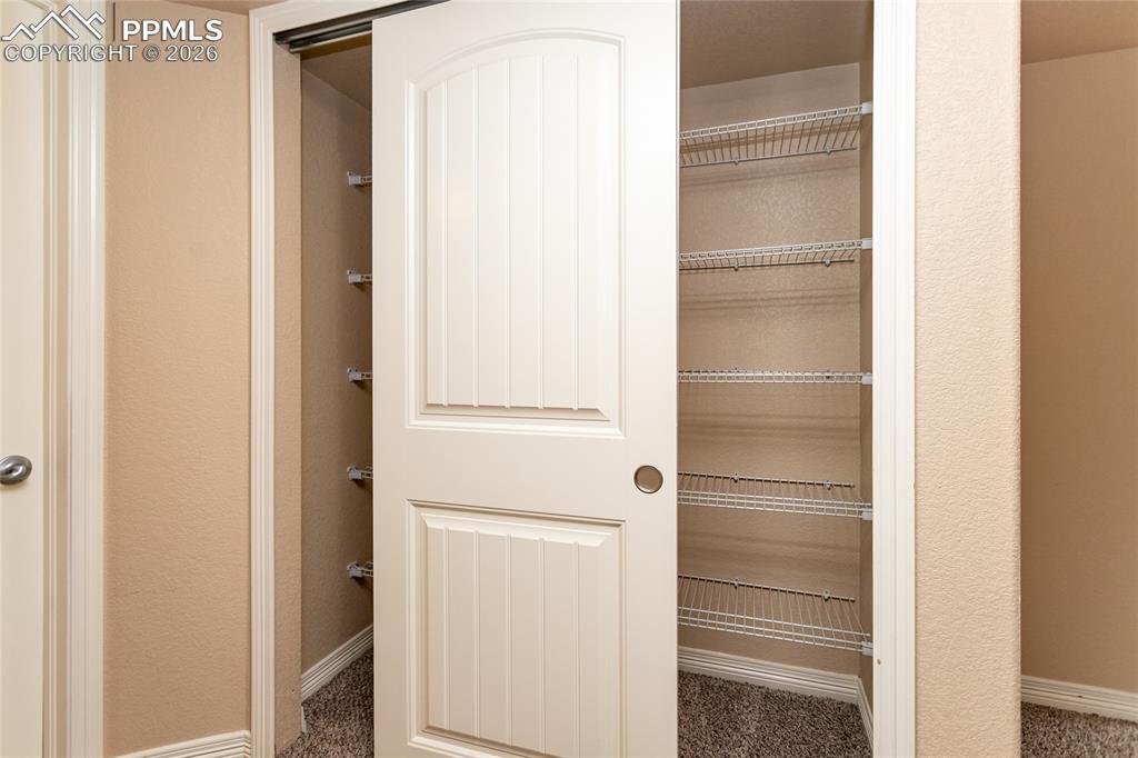 Image 19 of 49: Extra closet in primary bedroom