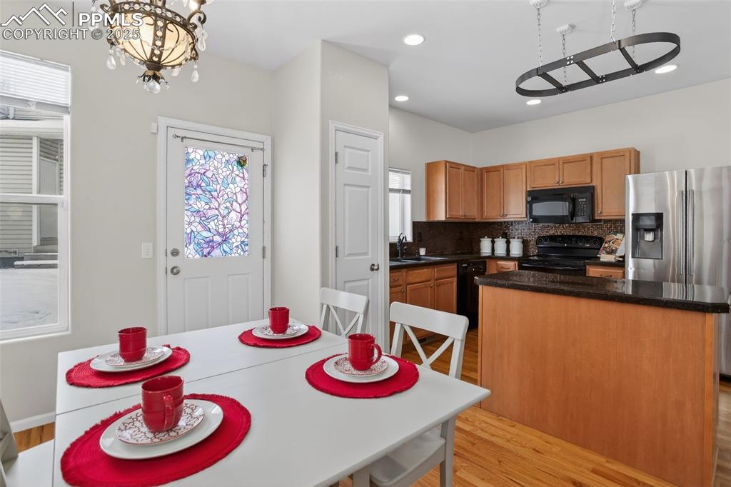 Image 15 of 36: Dining space right off the kitchen with access to the back of the structure