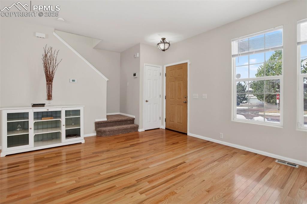 Image 5 of 36: Spacious and bright living room with hardwood flooring!